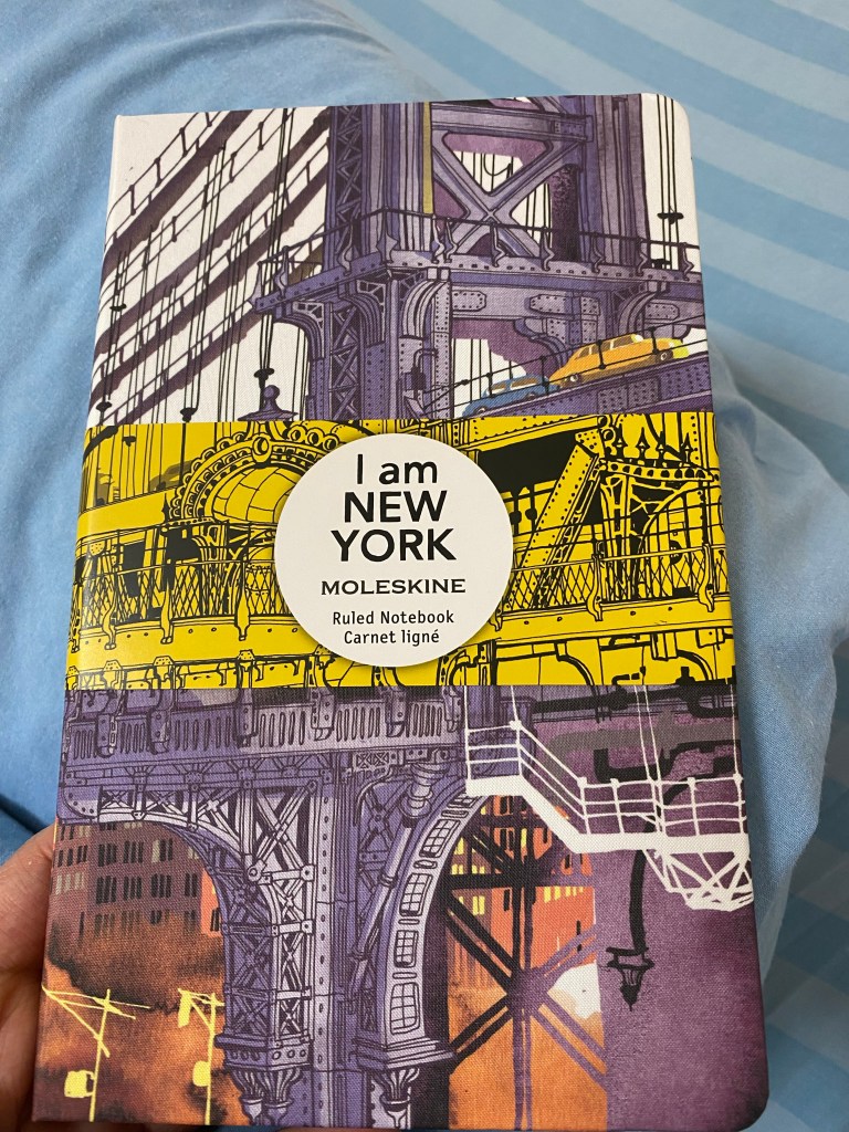 Brooklyn Bridge illustration on the front cover of the notebook, with yellow band on.