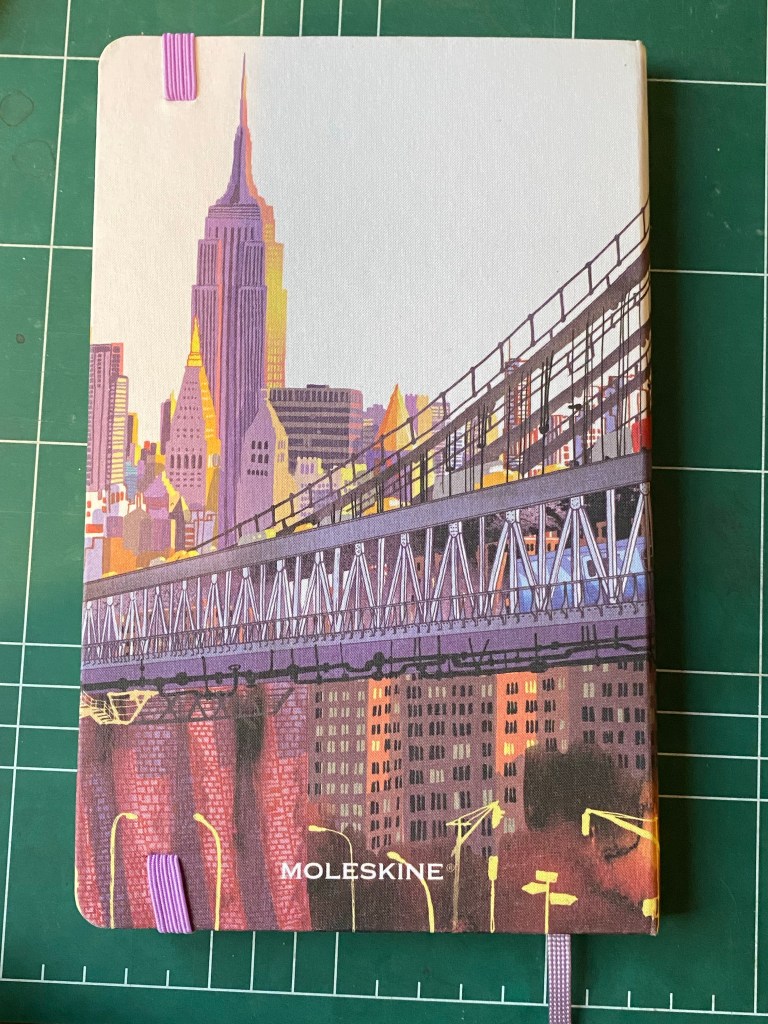 Moleskine I am New York back cover without the yellow bookmark, and with the lavender ribbon bookmark showing.